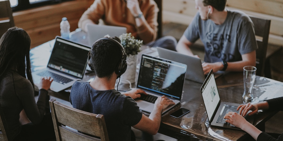 Remote team collaborating around laptops